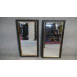 A pair of ebonised reeded framed wall mirrors with gilt slips. H.80 W.40cm