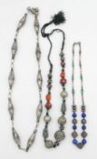 Three white metal and gemstone necklaces. One comprised of hollow silver plated elliptical beads
