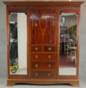 A C.1900 mahogany triple section compactum wardrobe with satinwood scrolling foliate, ribbon and