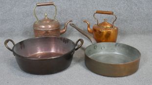 A collection of copper and brass kitchenware. Including two Victorian copper kettles, one engraved