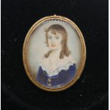 A 19th century yellow metal framed miniature on ivory pendant of a young boy with lace collar.