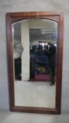 A mid century antique style full height oak mirror with arched bevelled plate. H.188 W.78cm (