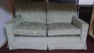 A floral upholstered two seater sofa. W.163 H.96 D.95