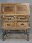 A mid century oak Jacobean style bureau. H100 W73 D48