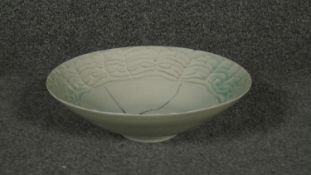 A Japanese celadon glaze bowl with cracked design and signed to base.