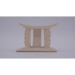 An early 20th century carved ivory African miniature headrest/ashanti stool. W.9 H.7 D.5