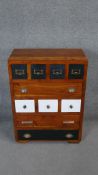 A contemporary hardwood chest of drawers fitted with two banks of spice drawers. H.89 W.67 D.36cm
