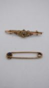 Two antique brooches. One rolled gold kilt pin set to the end with a cabochon sapphire, the other