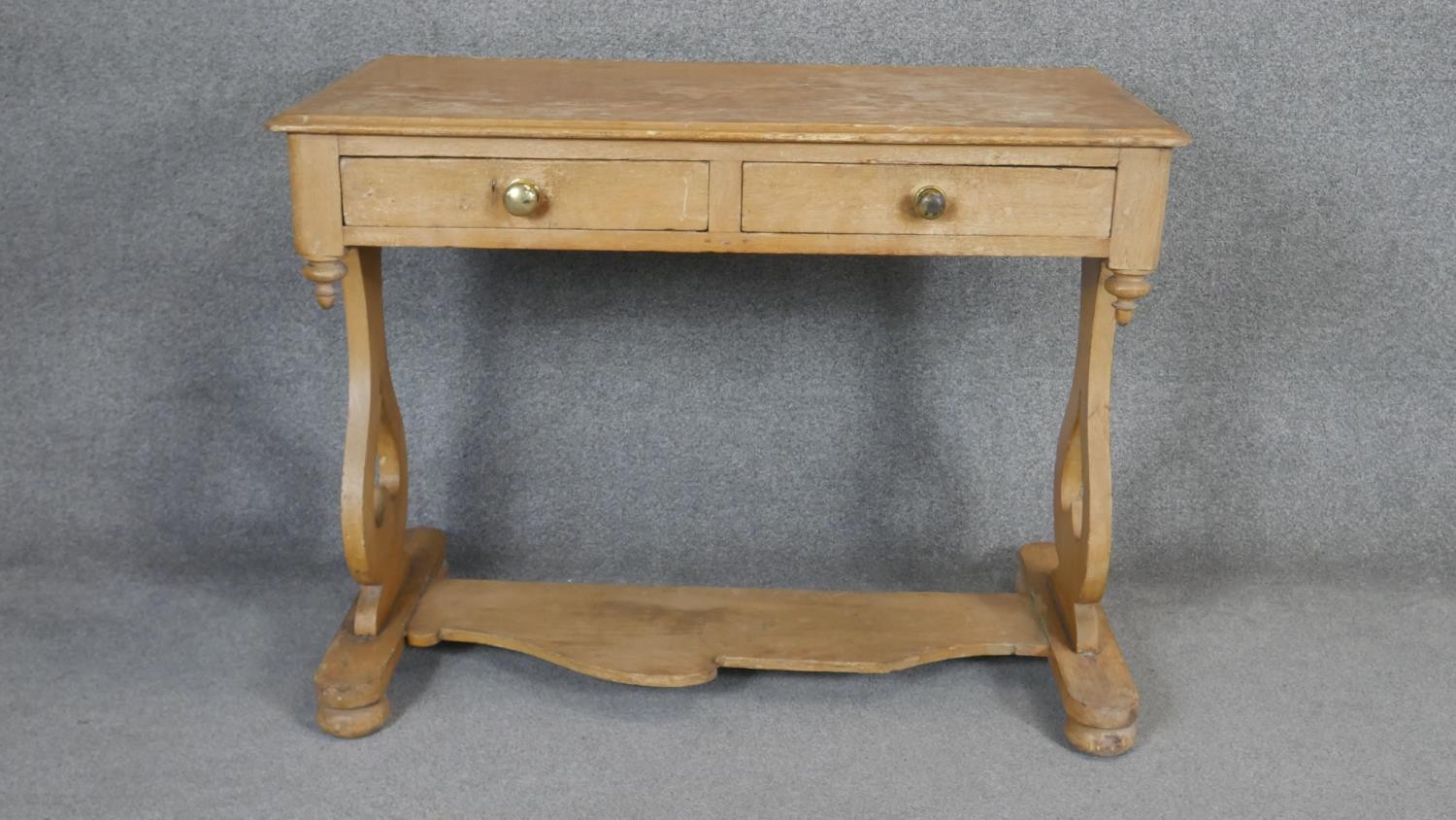 A 19th century pine two drawer side table on stretchered shaped supports. H.78 W.101 D.53cm