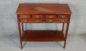 A Georgian style mahogany side table with a crossbanded top above six drawers on square tapering