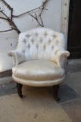 A Victorian tub nursing chair in buttoned floral damask upholstery on tapering fluted supports. H.72