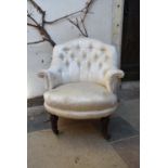 A Victorian tub nursing chair in buttoned floral damask upholstery on tapering fluted supports. H.72