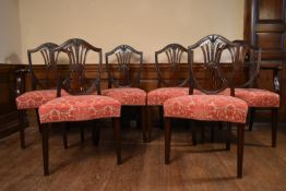 A set of six mahogany Hepplewhite style dining chairs with pierced vase shaped back splats above