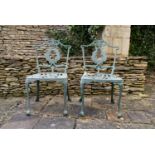 A pair of pierced wrought metal and painted garden chairs. H.82 W.42 D.42cm (2)