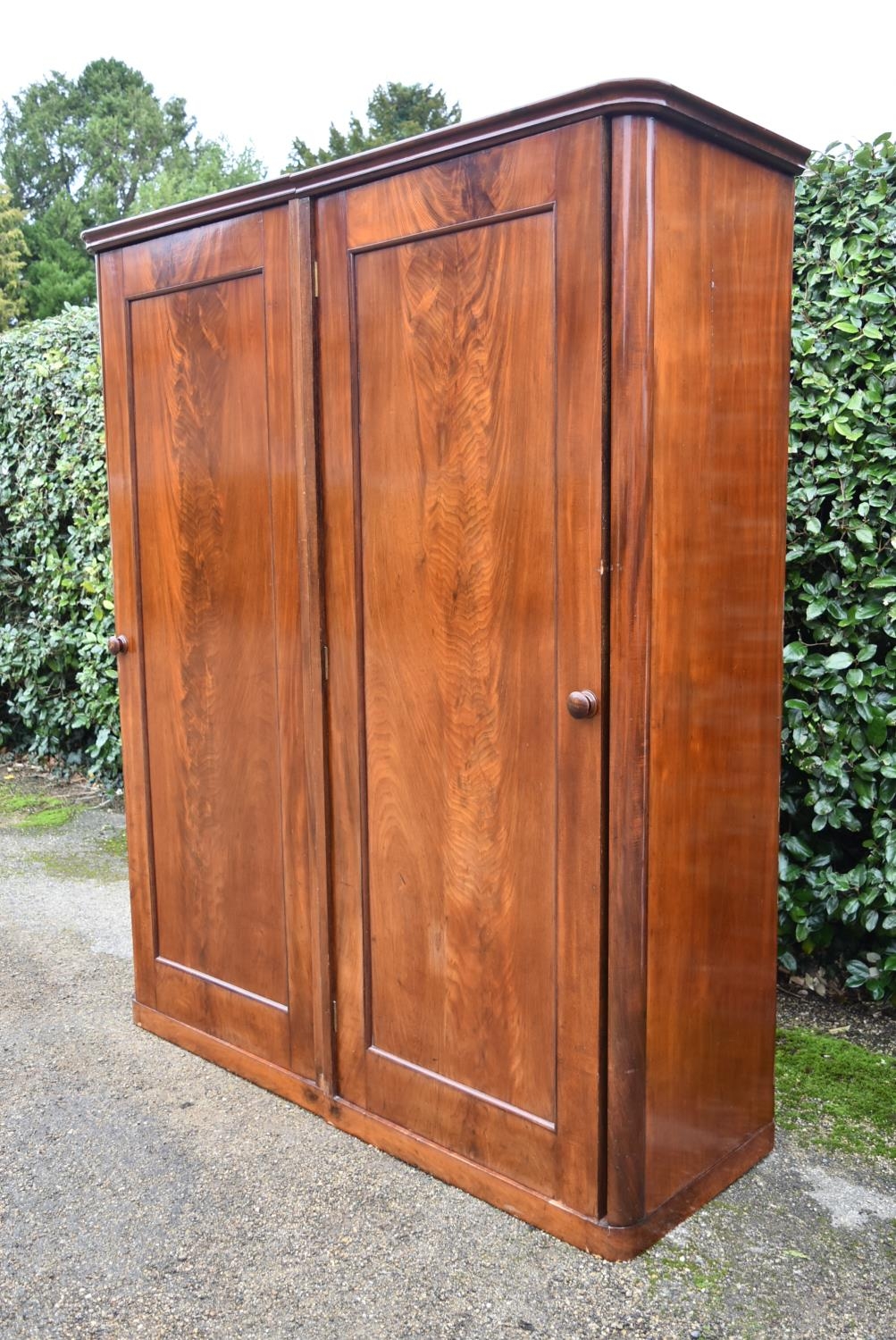 A 19th century flame mahogany two section wardrobe with panel doors enclosing full height hanging - Image 2 of 9