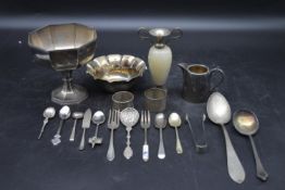 A collection of silverware. Including silver trophy, silver scalloped dish, a pair of silver