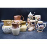 A collection of four Tobacco jugs, along with a collection of German beer steins. H.20 W.16cm (