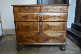 A William and Mary walnut chest with floral marquetry panels in various woods and oyster veneered