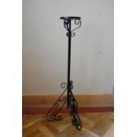 A wrought iron lamp stand on scrolling tripod base. H.105 Dia.18cm