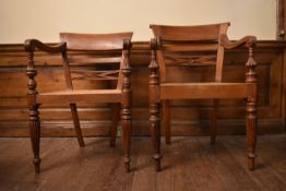 An Eastern teak Regency style open armchair with bar back above caned seat on reeded tapering