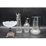 A collection of Edwardian style glassware. Including three claret jugs, one with repousse decoration
