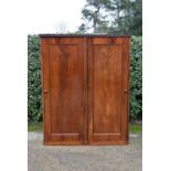 A 19th century flame mahogany two section wardrobe with panel doors enclosing full height hanging