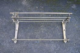 A 19th century brass wall hanging coat rack with luggage rack above coat hook rail. H.40 W.85 D.26cm