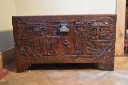 A carved Chinese camphorwood coffer. H.58 W.100 D.50cm