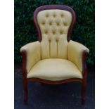 A 19th century style mahogany framed armchair in deep buttoned faux leather upholstery. H.102 W.70