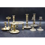 A collection of early 20th century brassware. Including three adjustable chamberstick, two pairs