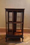 A C.1900 mahogany revolving bookcase on squat cabriole supports. H.88 W.50 D.49cm