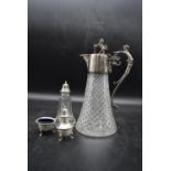 An early 20th century crystal cut glass claret jug with silver plated handle and lid, along with a