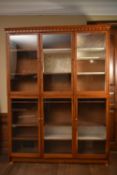 A large two section stained pine library bookcase or display cabinet. H.217 W.160 D.33cm