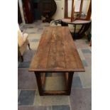 An 18th century country oak planked top refectory table with cleated ends resting on square