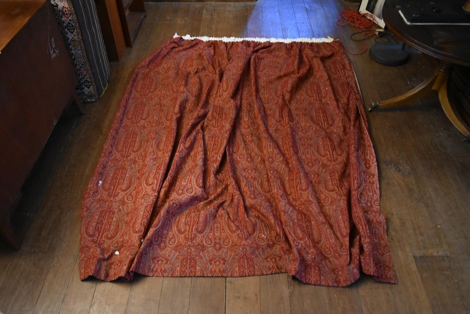 One large red lined tapestry curtain with repeating stylised scrolling foliate design. H.244 W.260cm