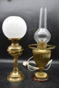 A 19th century converted duplex brass oil lamp on walnut base and one other similar with frosted