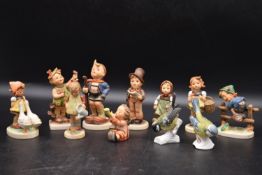 M.I Hummel - A collection of eleven vintage German porcelain figures. Including, little hiker,