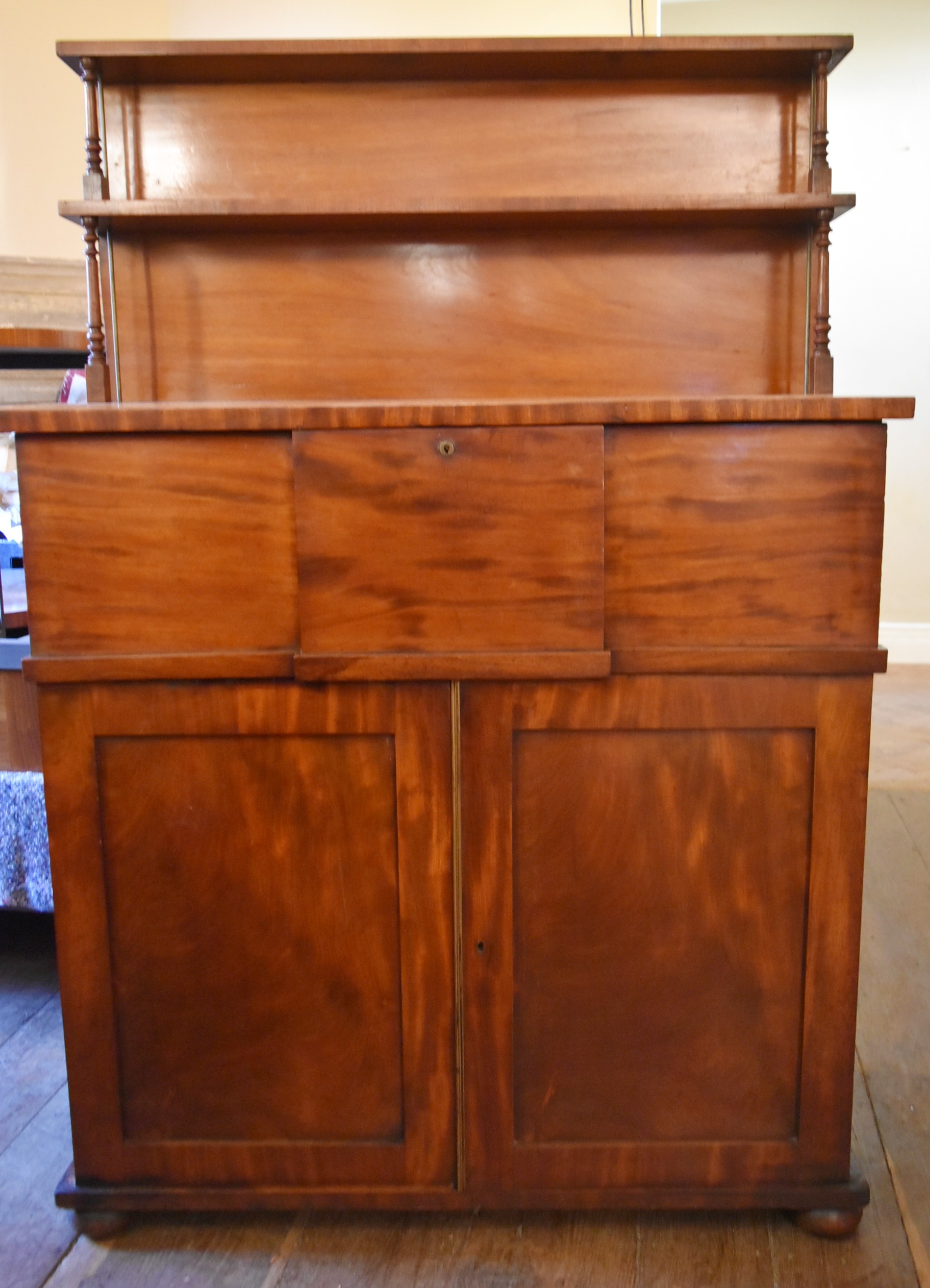 A 19th century mahogany chiffonier with raised and shelved upstand above deep frieze drawer and