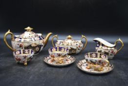 A part set of a handpainted Crown Derby - Old Imari Teaset. Including two cups and saucers, milk