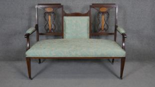 An Edwardian mahogany and satinwood cornucopia inlaid double chair end settee on square tapering
