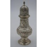 A large Victorian silver repousse sugar sifter with stylised floral and foliate design and shield