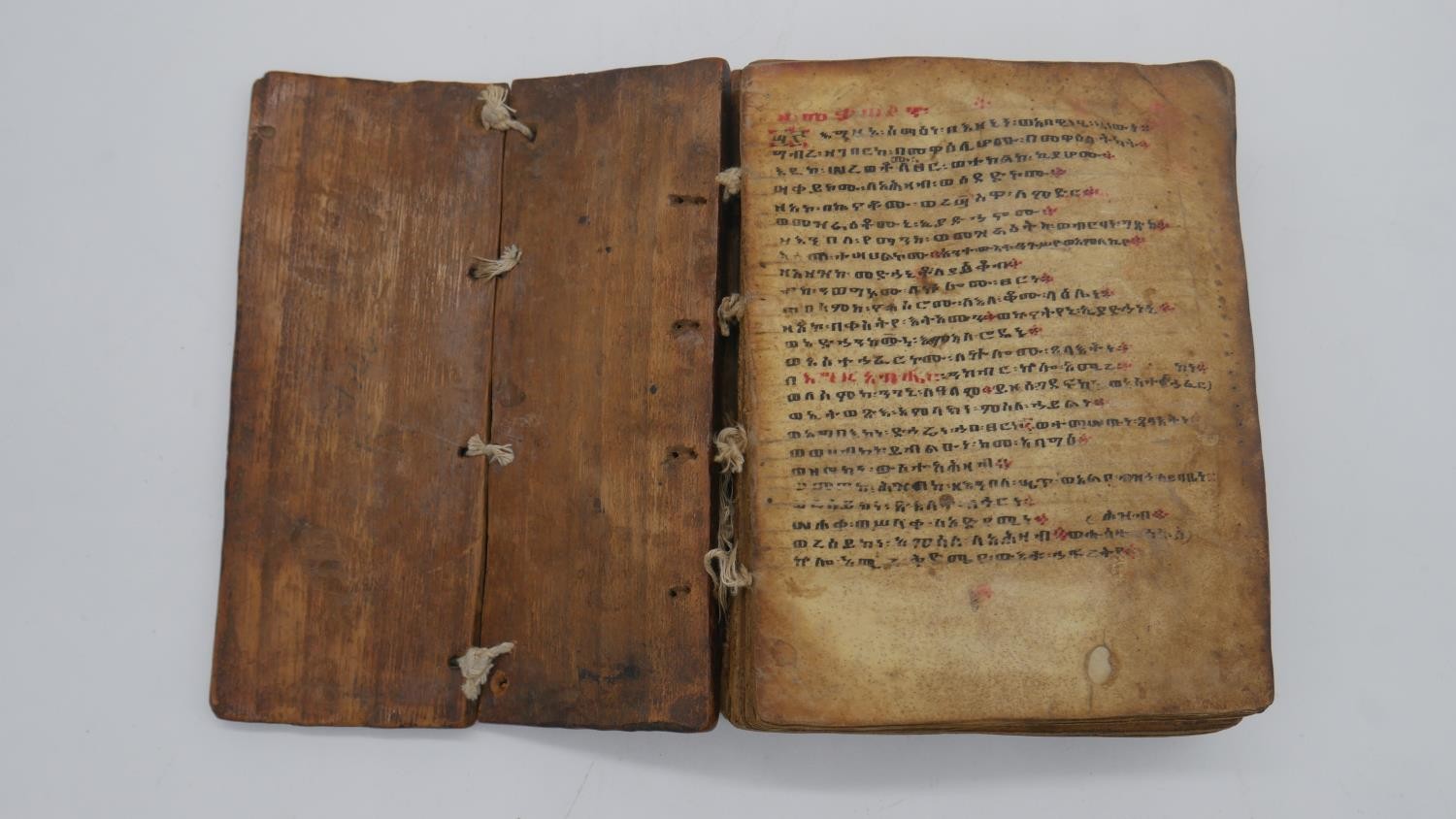 A 19th century Ethiopian coptic manuscript on vellum in wooden boards. Handwritten script in red and - Image 2 of 8