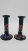 A pair of Moorcroft Anemone pattern (Blue) tall candlesticks. With impressed date cypher (1993)