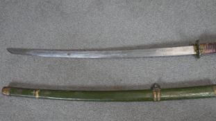 A Meji period Japanese katana with green painted sheath, brass detailing and engraved characters