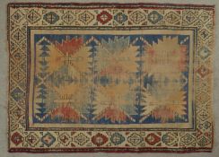 A late 19th century Caucasian Kazak rug with repeating star medallions on a sapphire ground within