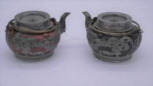 Two Chinese vintage Yixing pottery tea pots with pewter dragon pierced overlays. One with black