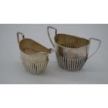 A Victorian gadrooned silver sugar bowl and milk jug. Hallmarked:JMB for John Millward Banks,