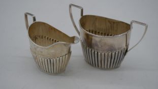 A Victorian gadrooned silver sugar bowl and milk jug. Hallmarked:JMB for John Millward Banks,