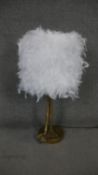 A desk lamp with white feather shade and gilt resin bird leg stem. H.78cm