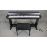 A Yahama Clavinova CLP-650 digital piano with matching stool. H.83 W.140 D.47cm (Damage to case as